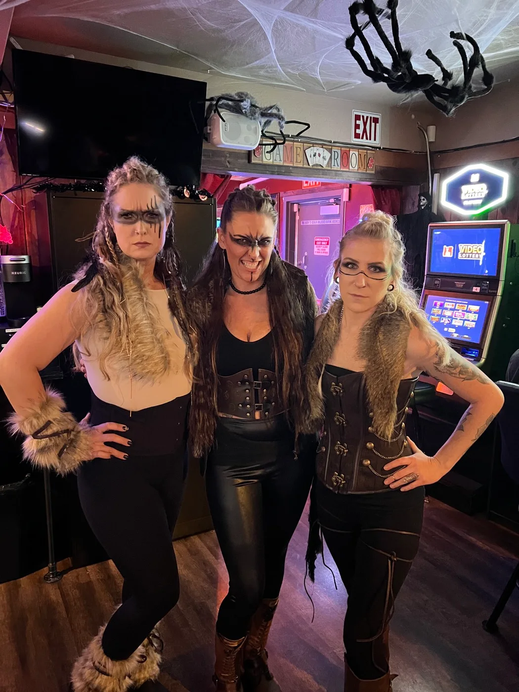 Three guests dressed for a costume night at Flespy’s